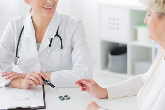 The doctor explains to the woman at the appointment about the causes and solutions of Vaginal Atrophy During Menopause